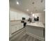 Modern kitchen with an island, stainless steel appliances, and white cabinets at 871 City Walk Ln # B-1, Oviedo, FL 32765