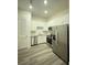 Modern kitchen featuring stainless steel appliances, white cabinets, and granite countertops at 871 City Walk Ln # B-1, Oviedo, FL 32765
