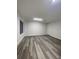 Spacious living room featuring modern flooring, white walls, and recessed lighting at 871 City Walk Ln # B-1, Oviedo, FL 32765