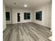 Spacious living room with luxury vinyl floors and natural lighting at 871 City Walk Ln # B-1, Oviedo, FL 32765