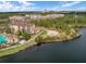 Beautiful aerial view of community bordering a serene lake, lush greenery, and walking paths at 8762 Worldquest Blvd # 6506, Orlando, FL 32821