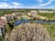 Scenic aerial view overlooking lush landscaping, a tranquil lake, and resort-style community at 8762 Worldquest Blvd # 6506, Orlando, FL 32821