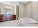 Spacious bathroom featuring a soaking tub and a double vanity at 8762 Worldquest Blvd # 6506, Orlando, FL 32821