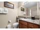 Well-lit bathroom with granite countertops, a decorative mirror, and towel rack at 8762 Worldquest Blvd # 6506, Orlando, FL 32821