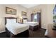 Bedroom with two beds, dark carpet, and stylish décor at 8762 Worldquest Blvd # 6506, Orlando, FL 32821