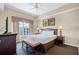 Well-lit bedroom with a large window and classic furnishings at 8762 Worldquest Blvd # 6506, Orlando, FL 32821