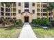 Inviting building entrance with well-maintained landscaping leading to a covered entryway and the building number at 8762 Worldquest Blvd # 6506, Orlando, FL 32821