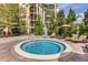 Inviting hot tub surrounded by lounge chairs and lush landscaping, perfect for relaxation and socializing at 8762 Worldquest Blvd # 6506, Orlando, FL 32821
