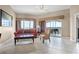 Inviting living room featuring tile floors, a cozy sofa, and natural light from the balcony at 8762 Worldquest Blvd # 6506, Orlando, FL 32821