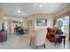 Open-concept living space with comfortable seating, tile floors, and access to the kitchen and patio at 8762 Worldquest Blvd # 6506, Orlando, FL 32821