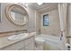 Well-lit bathroom featuring a marble countertop, decorative mirror and bathtub with tiled shower at 100 S Interlachen Ave # 304, Winter Park, FL 32789