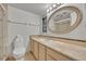 Bathroom features a marble countertop vanity, an oval mirror, and a shower behind glass at 100 S Interlachen Ave # 304, Winter Park, FL 32789