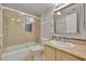 Bathroom features a marble countertop vanity, an ornate mirror, and a shower and tub behind glass at 100 S Interlachen Ave # 304, Winter Park, FL 32789