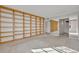 The bedroom features neutral carpet, large built-in shelving, and a mirrored wall at 100 S Interlachen Ave # 304, Winter Park, FL 32789