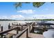 Dock on the water with boat slips, wood decking, and blue skies above at 100 S Interlachen Ave # 304, Winter Park, FL 32789