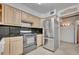 Well-lit kitchen featuring stainless steel appliances, bright cabinets and dark backsplash at 100 S Interlachen Ave # 304, Winter Park, FL 32789