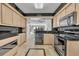 Kitchen with black countertops and stainless steel appliances at 100 S Interlachen Ave # 304, Winter Park, FL 32789