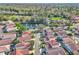 An aerial view of community houses with lake view, mature trees and well-kept lawns at 1008 Birkdale Trl, Winter Springs, FL 32708