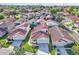 Aerial view of a neighborhood featuring tile roofs, green lawns and mature trees at 1008 Birkdale Trl, Winter Springs, FL 32708