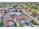 Aerial view of a neighborhood featuring tile roofs, community pool, lake, and golf course at 1008 Birkdale Trl, Winter Springs, FL 32708