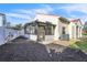 Backyard with black mulch and a screened-in lanai attached to the back of a stucco home at 1008 Birkdale Trl, Winter Springs, FL 32708