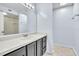 Bathroom with a large mirror over the white countertop and gray cabinets at 1008 Birkdale Trl, Winter Springs, FL 32708