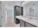 Bathroom featuring a white countertop, dark cabinets, and a large mirror at 1008 Birkdale Trl, Winter Springs, FL 32708