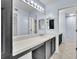 Bathroom with large mirror, white countertop, and dark cabinets at 1008 Birkdale Trl, Winter Springs, FL 32708
