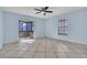 Light blue bedroom with tile floors, ceiling fan, sliding glass door, and window at 1008 Birkdale Trl, Winter Springs, FL 32708