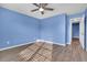 Bedroom with ceiling fan, wood floors, and a doorway at 1008 Birkdale Trl, Winter Springs, FL 32708