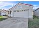 Exterior showcasing a two-car garage with decorative detailing, a red tile roof, and tidy landscaping at 1008 Birkdale Trl, Winter Springs, FL 32708
