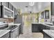 Modern kitchen with stainless steel appliances, mosaic backsplash, and quartz countertops at 1008 Birkdale Trl, Winter Springs, FL 32708