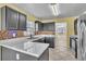 Beautiful kitchen featuring modern cabinets, quartz countertops, stainless steel appliances and mosaic backsplash at 1008 Birkdale Trl, Winter Springs, FL 32708