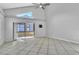 Bright living room with tile flooring, sliding glass doors, and a modern ceiling fan at 1008 Birkdale Trl, Winter Springs, FL 32708