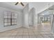 Open-concept living room with tile flooring, high ceilings with fans, and ample natural light at 1008 Birkdale Trl, Winter Springs, FL 32708