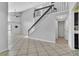 Spacious living room featuring tile floors, staircase to upper floor, and access to other rooms at 1008 Birkdale Trl, Winter Springs, FL 32708