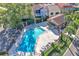 Aerial view of community pool with lounge chairs, tables and lush landscaping at 1008 Birkdale Trl, Winter Springs, FL 32708