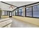 A sunroom has many windows, tile flooring, and a ceiling fan for optimal lighting and comfort at 1008 Birkdale Trl, Winter Springs, FL 32708