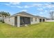 Exterior view of the backyard featuring a well-maintained lawn and a stucco home at 105 Adoncia Way, Sanford, FL 32771
