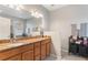 Bathroom featuring double sinks, granite countertop, and a large mirror at 105 Adoncia Way, Sanford, FL 32771