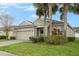 Well-maintained home with a two-car garage, nicely landscaped front yard and a beautiful shade tree at 105 Adoncia Way, Sanford, FL 32771