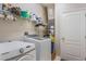 Efficient laundry room with modern washer and dryer, storage shelves, and ample space at 105 Adoncia Way, Sanford, FL 32771