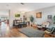 Cozy living room with ample seating, hardwood floors, and a seamless connection to other living areas at 105 Adoncia Way, Sanford, FL 32771