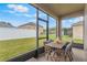 Enclosed back porch with a dining table set and view of the backyard at 105 Adoncia Way, Sanford, FL 32771