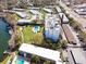 Aerial view of condominium featuring a community pool, green space and boat docks at 1100 S Orlando Ave # 301, Maitland, FL 32751