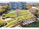 Aerial view of condo featuring waterfront access, a pool, and beautifully maintained grounds at 1100 S Orlando Ave # 301, Maitland, FL 32751