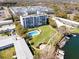 Aerial view of condominium featuring a pool, boat docks, and lovely green spaces at 1100 S Orlando Ave # 301, Maitland, FL 32751