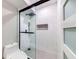 Bathroom showcasing a tiled shower stall with frameless glass doors at 1100 S Orlando Ave # 301, Maitland, FL 32751