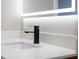 Modern bathroom featuring a sleek black faucet, under cabinet lighting, and a backlit mirror at 1100 S Orlando Ave # 301, Maitland, FL 32751