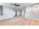 Bedroom featuring a ceiling fan, sliding closet doors, and wood look floors at 1100 S Orlando Ave # 301, Maitland, FL 32751